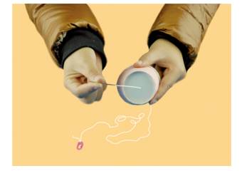 Thread the needle through the bottom of a paper cup