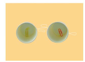 Thread the needle through the bottom of another paper cup